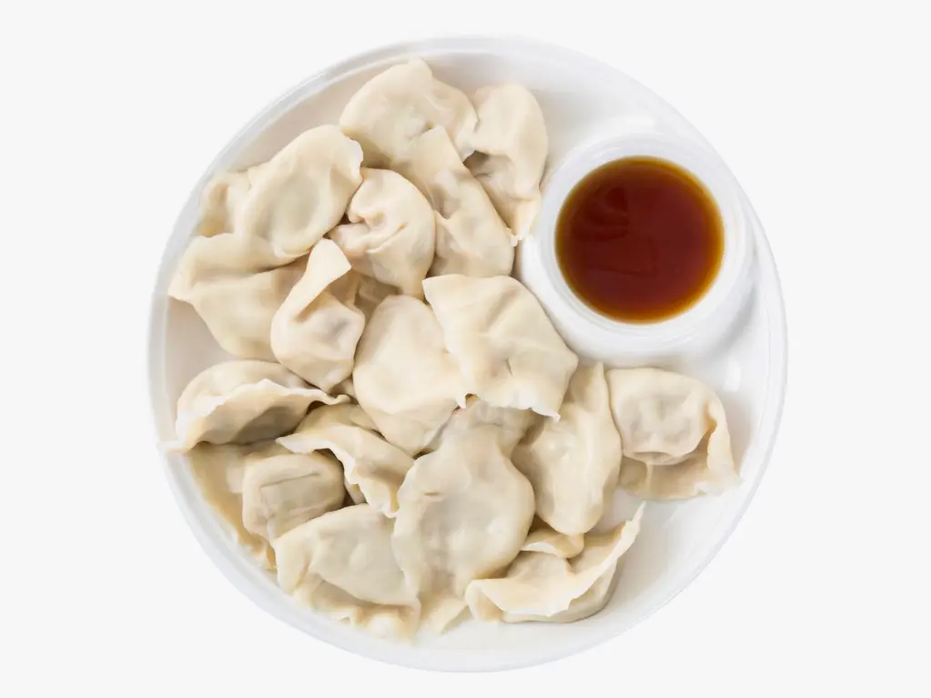 Steamed pork and napa cabbage dumplings served with soy sauce