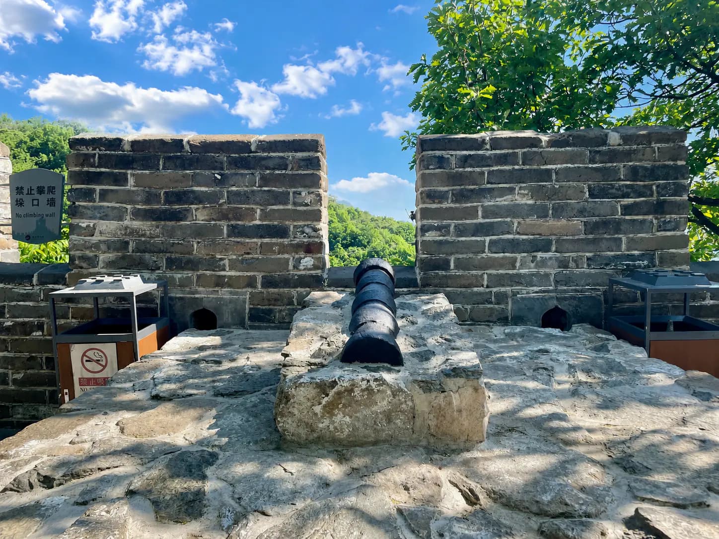 Ming Dynasty iron cannon preserved below a Mutianyu watchtower.