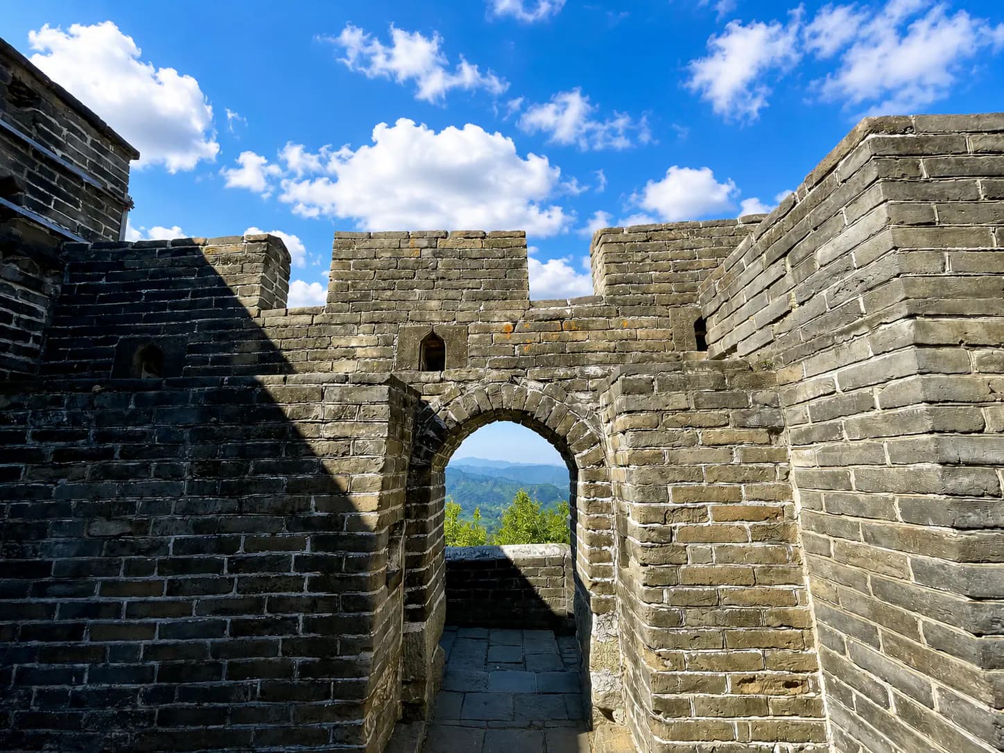 Preserved Mutianyu stone convenient access door with arch and drainage hole beneath the threshold.