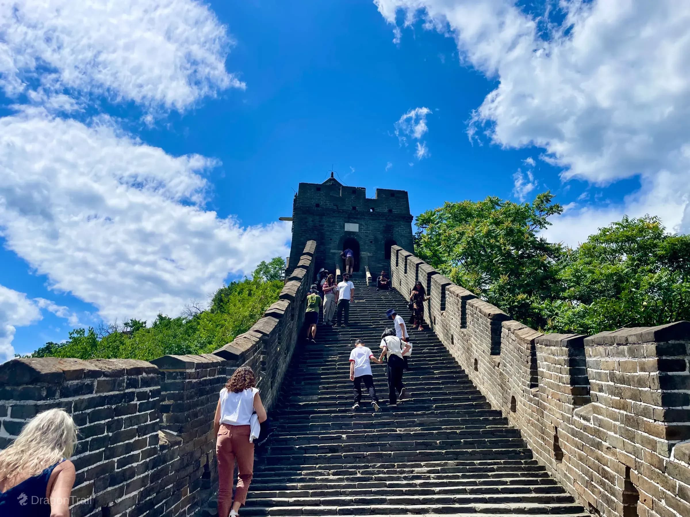 Tourists climbing steep Mutianyu stairs toward Tower 5