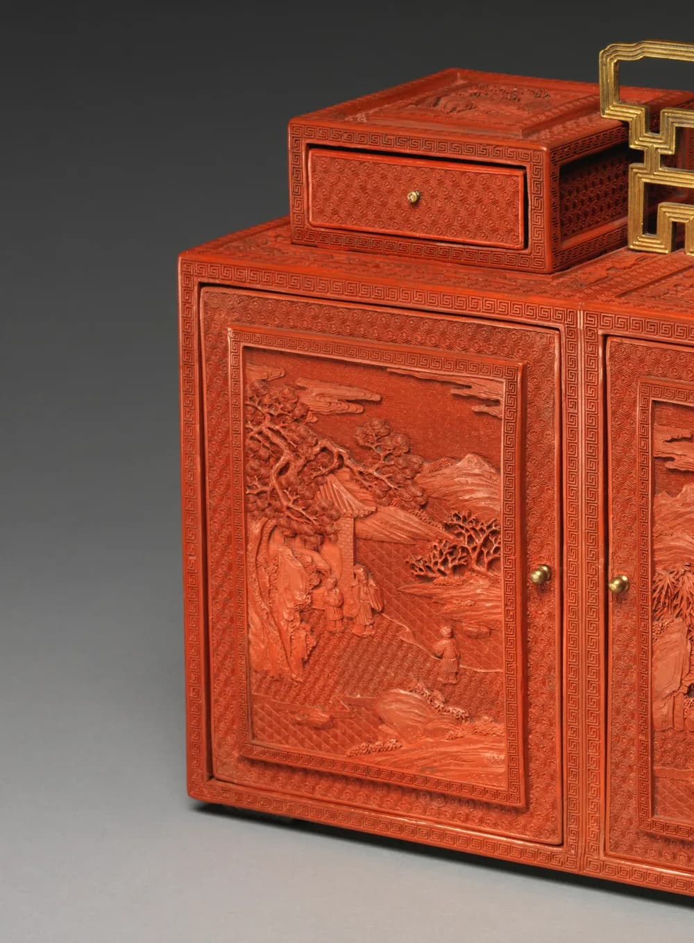 Detail of carved red lacquer relief on an 18th-century Qianlong-period cabinet
