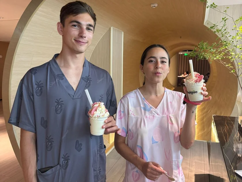 Two guests in spa pajamas holding drinks at a Beijing 24-hour spa, from Isabella’s GetYourGuide review.