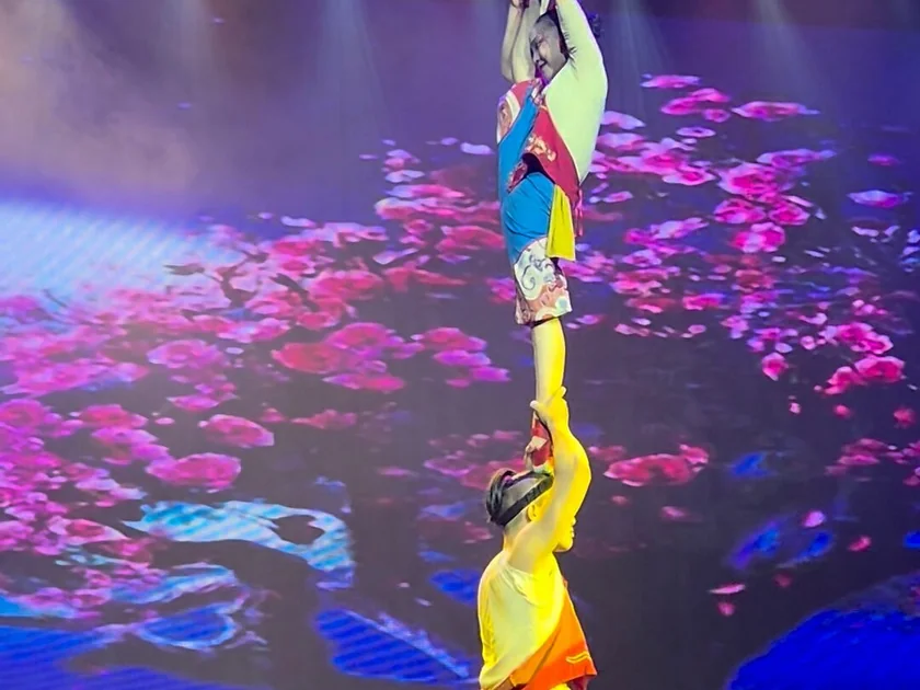 Acrobats performing on stage at Beijing Red Theatre during a Chinese acrobatics show.