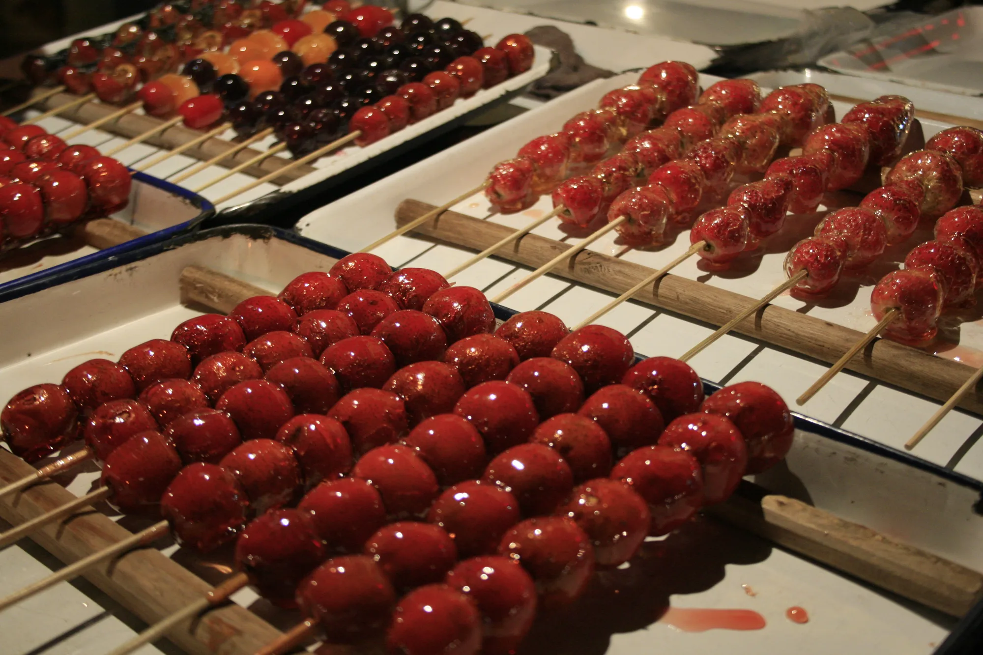 Red fruit tanghulu covered in a hard sugar shell