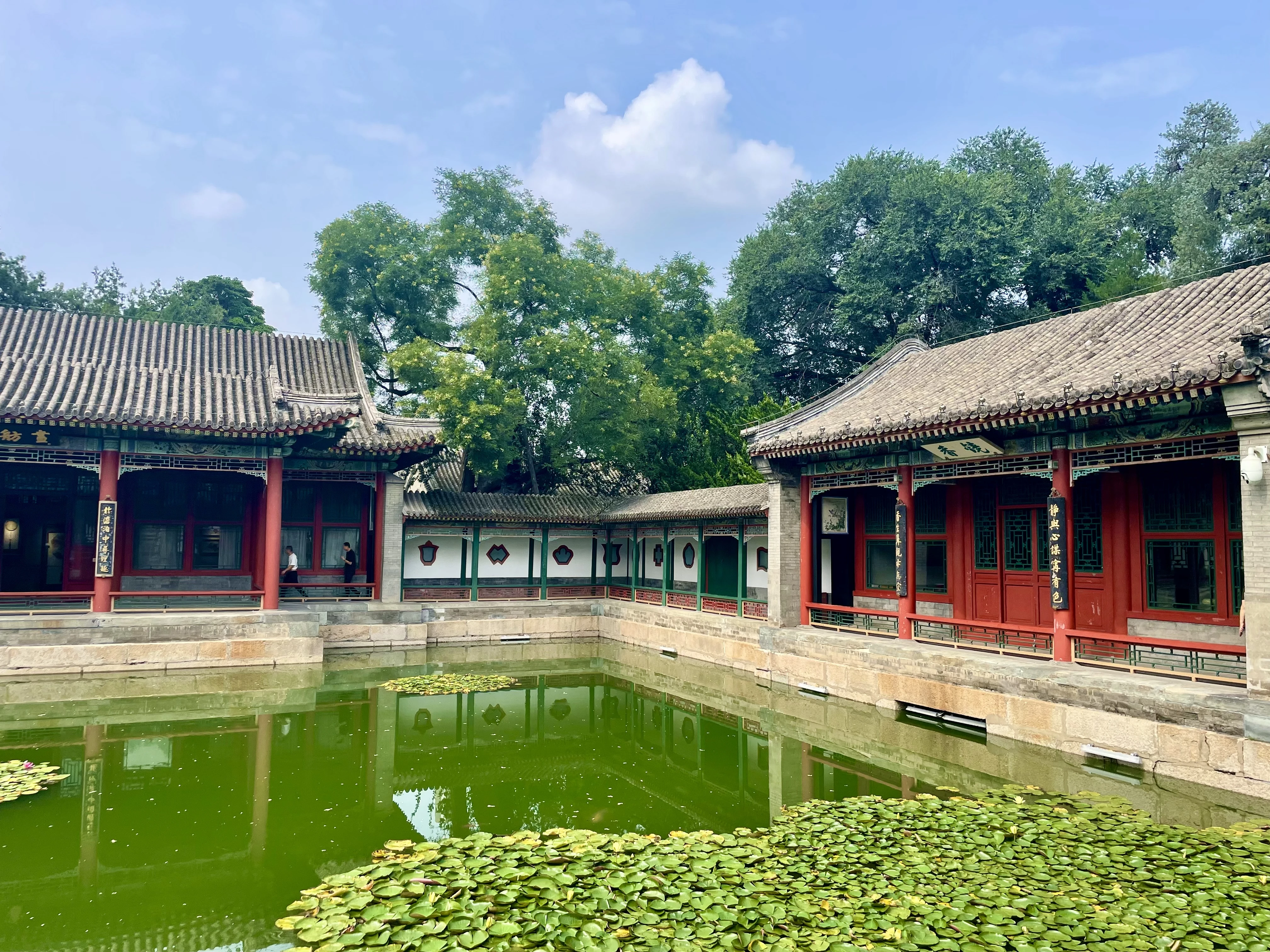 Lily pond courtyard with red-pillared pavilions and covered walkway at Beihai Park, Beijing