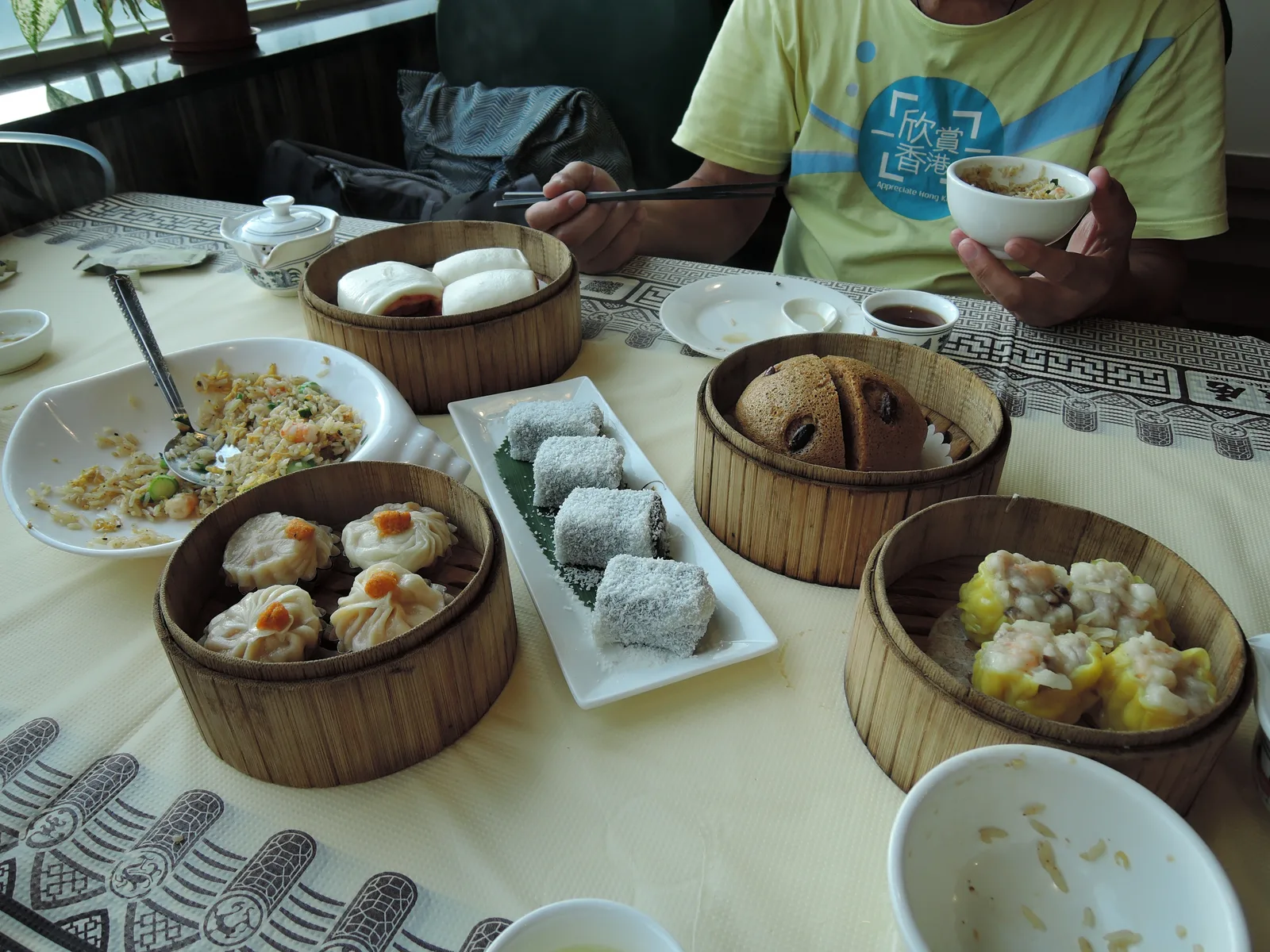 Assorted dim sum steamer baskets and small plates