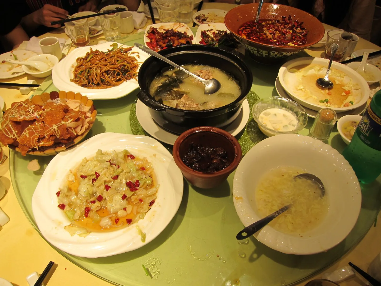 Chinese dining table setting with shared dishes, rice bowls and chopsticks