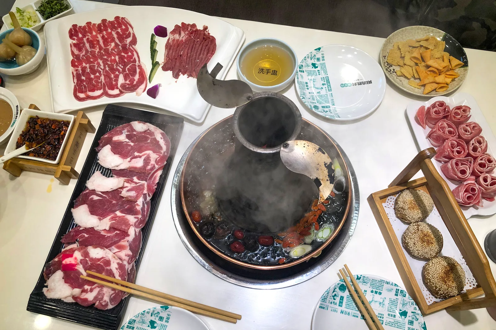 Beijing-style instant-boiled mutton hot pot with thin-sliced lamb and a copper pot—shown here as regional Beijing mutton dining context, not as proof of a halal kitchen