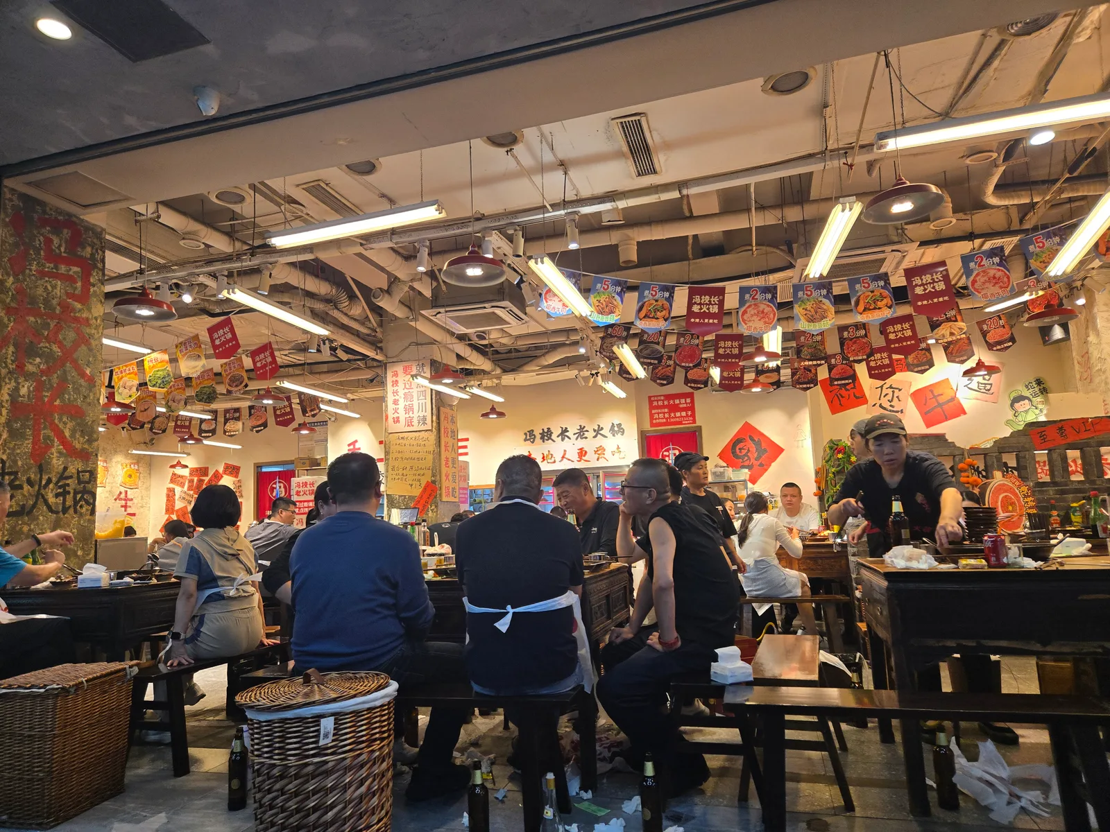 Diners sharing a hotpot meal at a restaurant table in Chengdu
