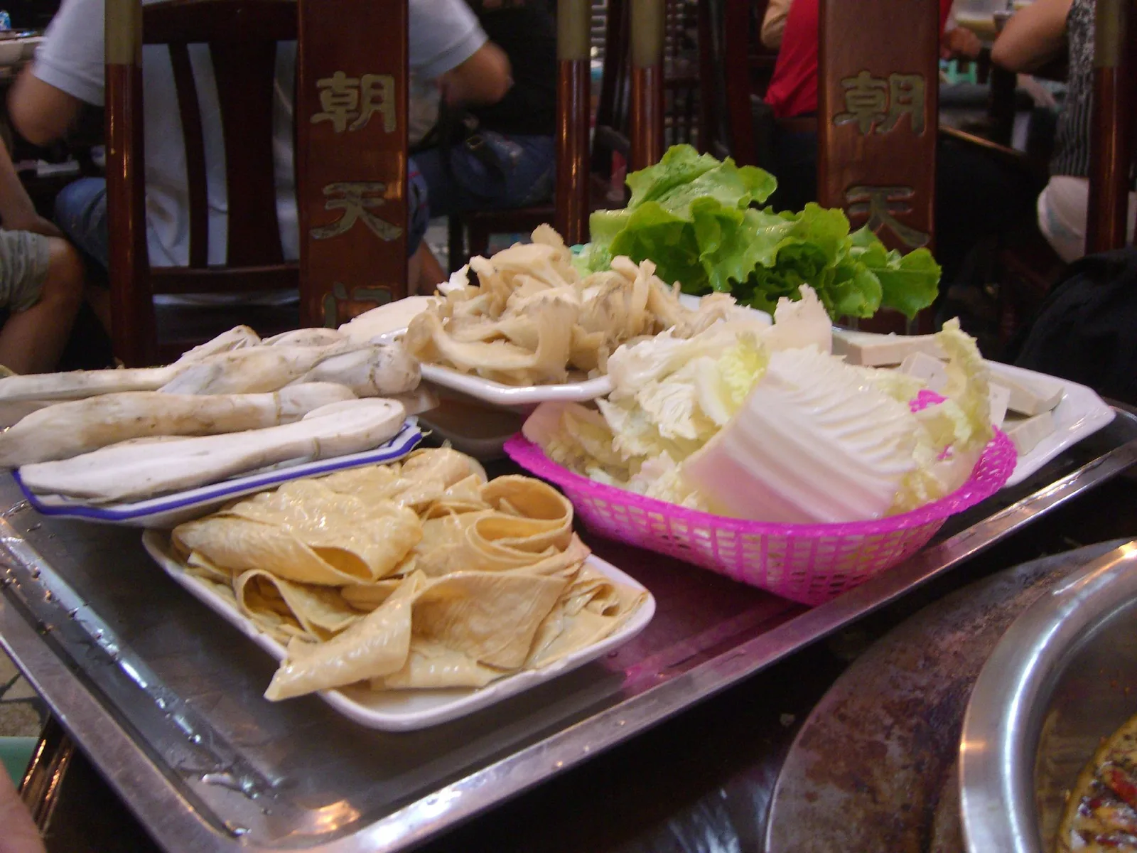 Fresh vegetables and mushroom platters prepared for Sichuan-style hot pot