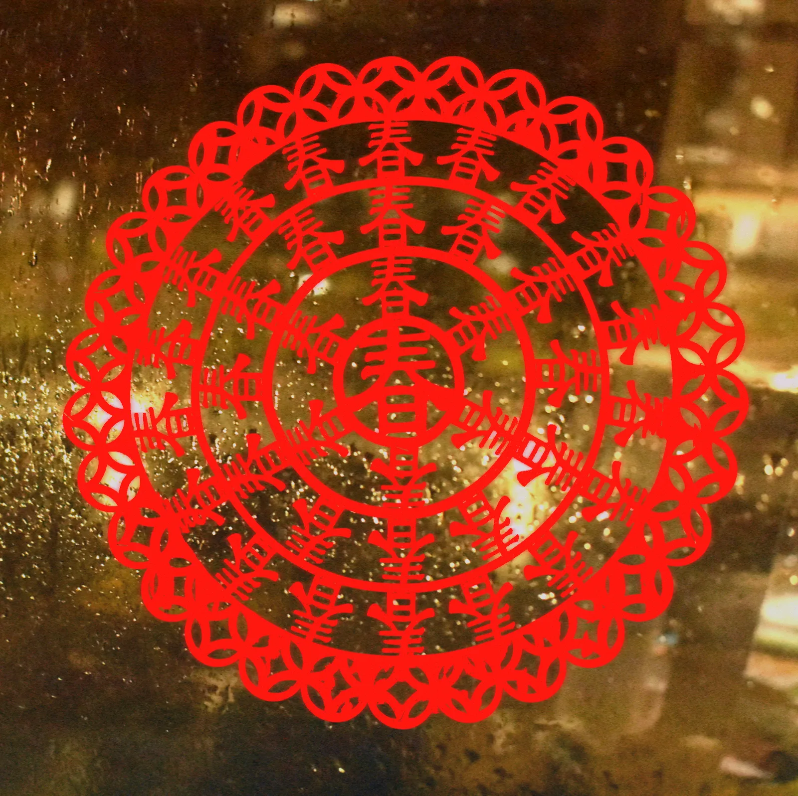 Red Chinese paper cut featuring the character for spring