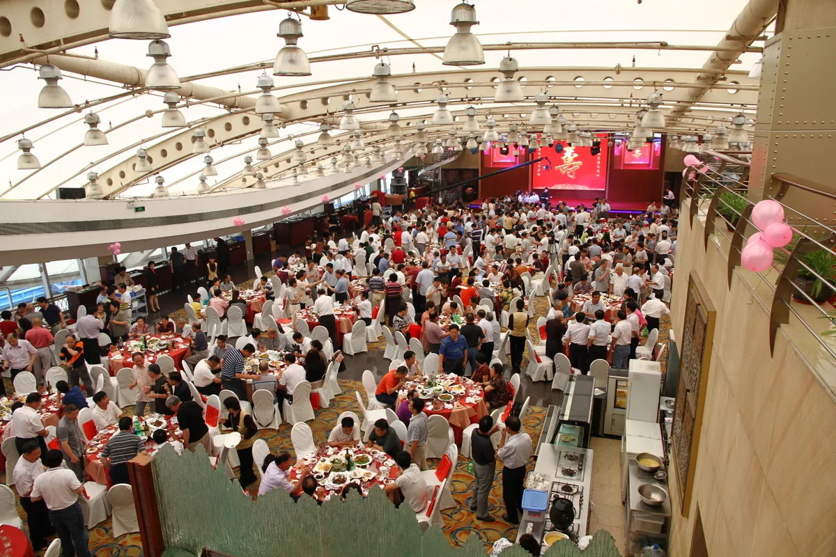 Guests seated around tables at a Chinese banquet