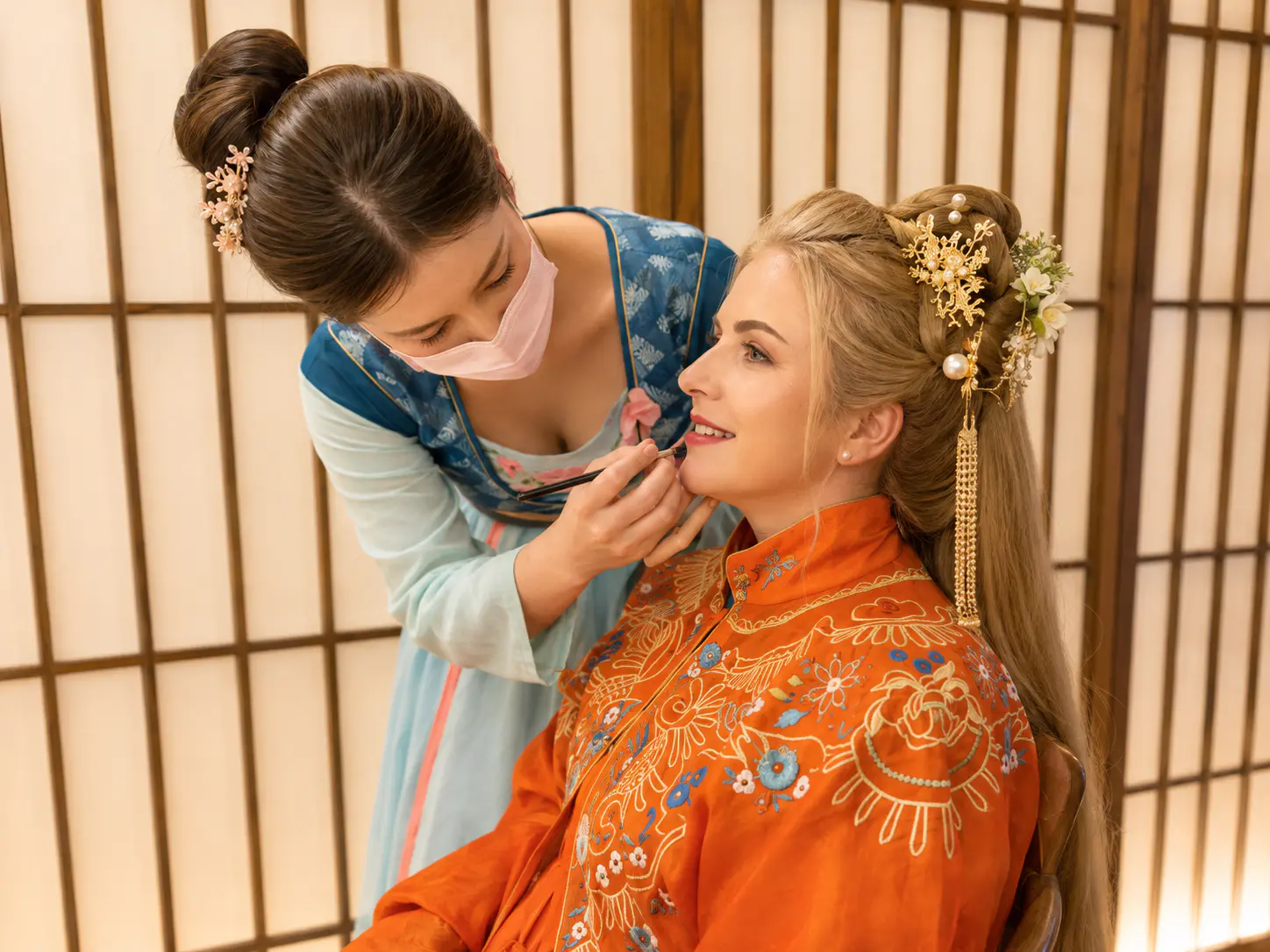 Makeup artist applying finishing colour during a Beijing Hanfu dressing and styling session.