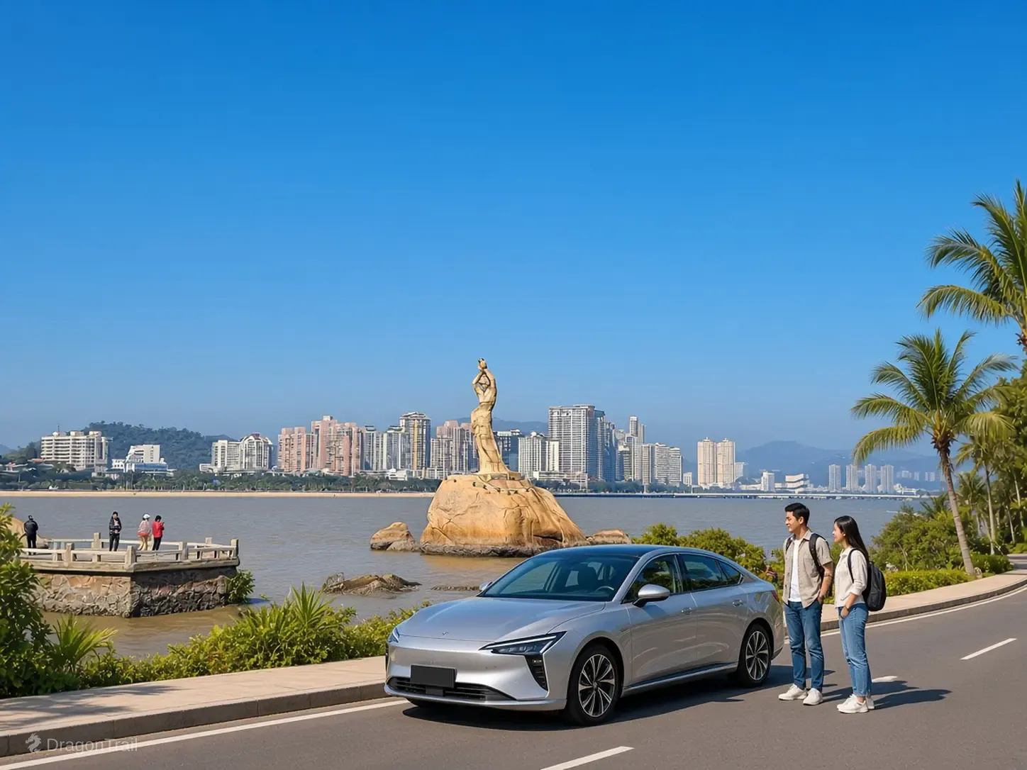 Two people stand beside a silver sedan on a coastal road pull-off, with the Fisher Girl statue and the Zhuhai skyline across the water