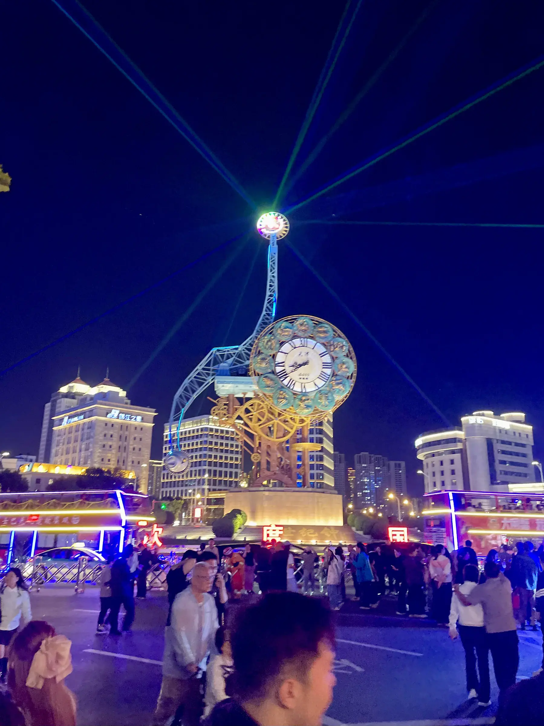 Illuminated clock tower with laser beams at night in central Tianjin