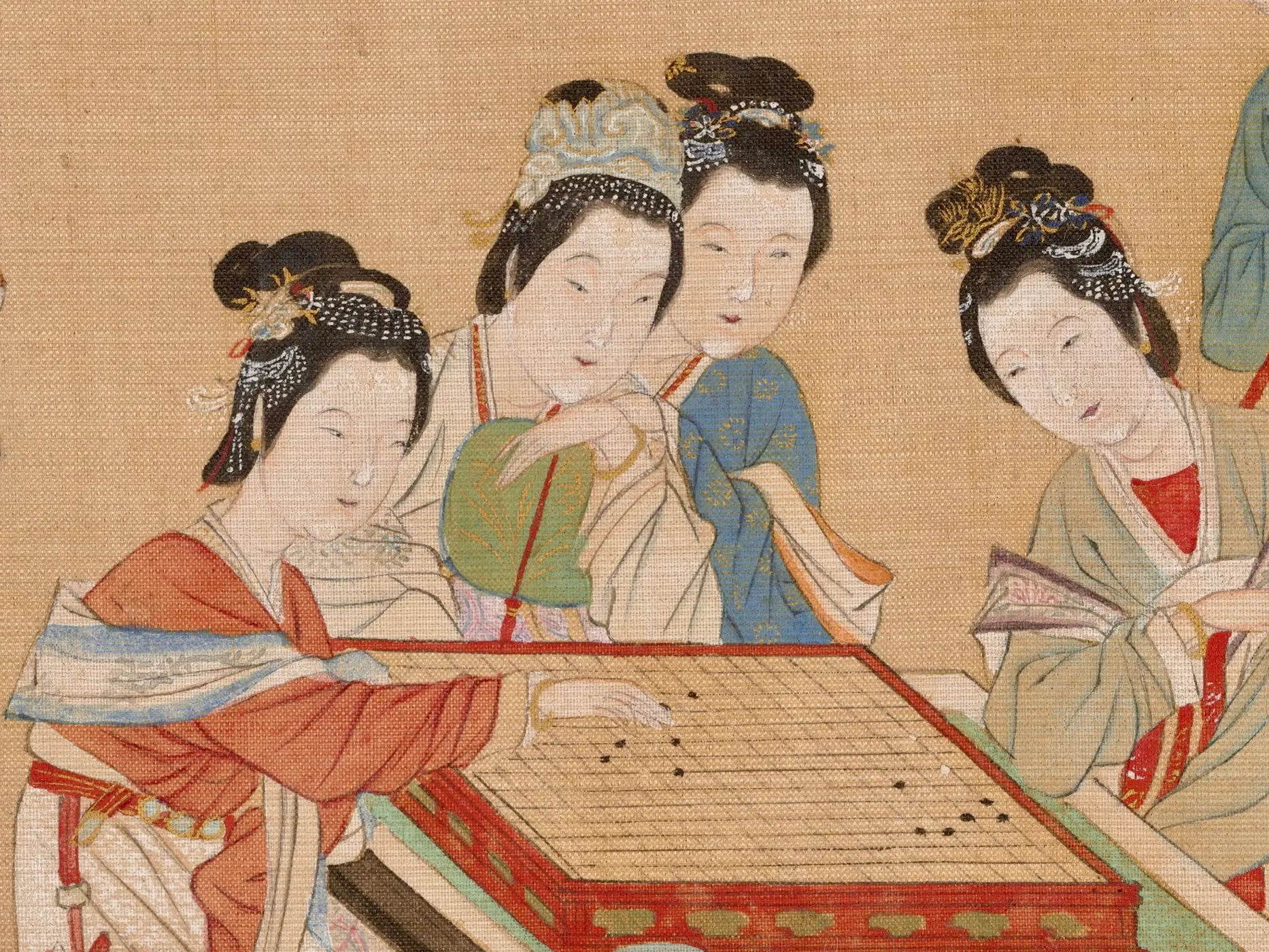 Mujeres elaboradamente vestidas reunidas alrededor de una mesa en una pintura china